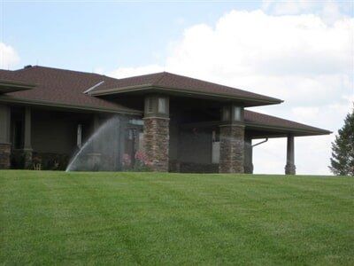 House Sprinkler — Sprinklers in Front of House in Omaha, NE