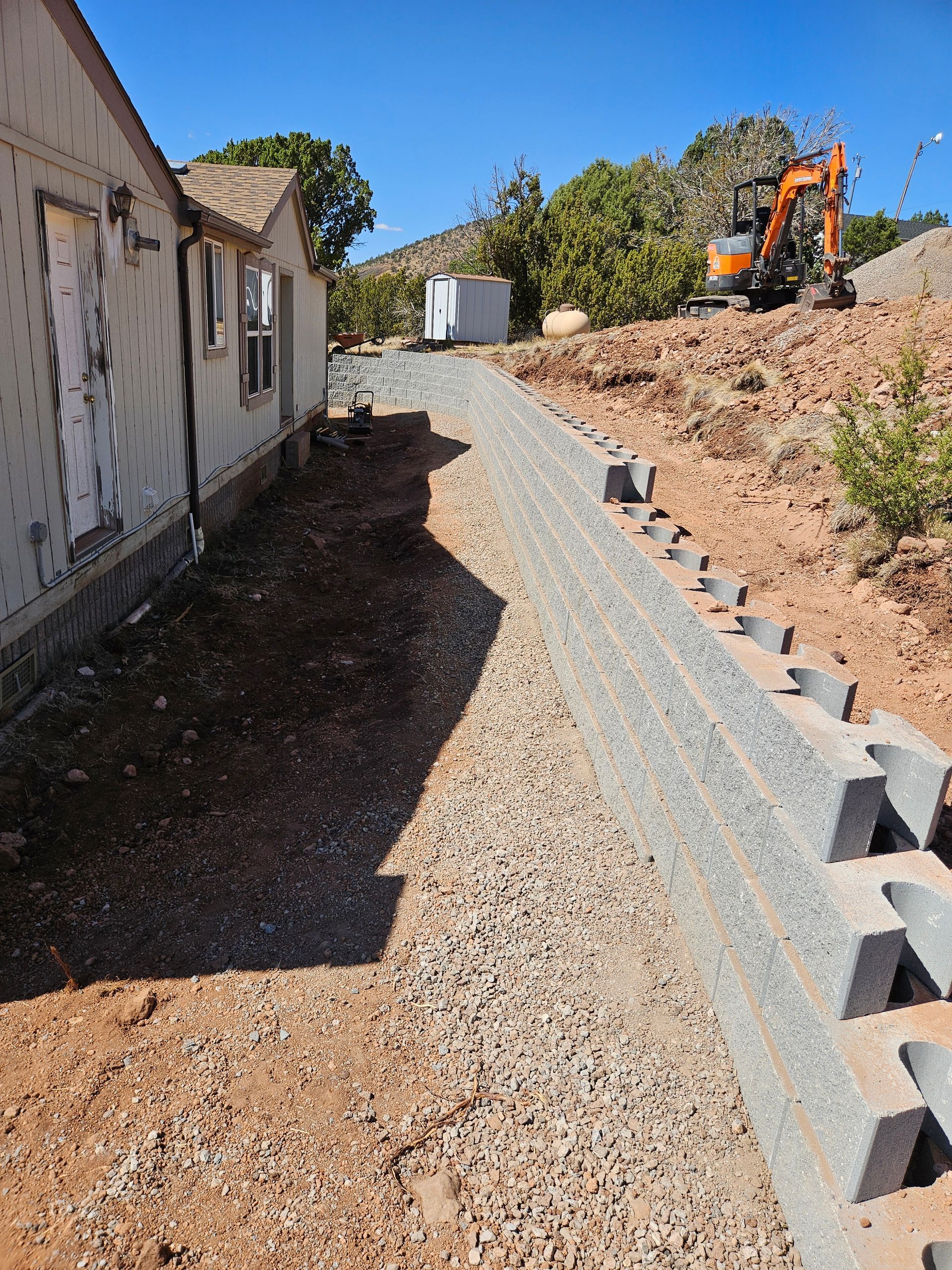 A white dump truck is parked in a dirt field