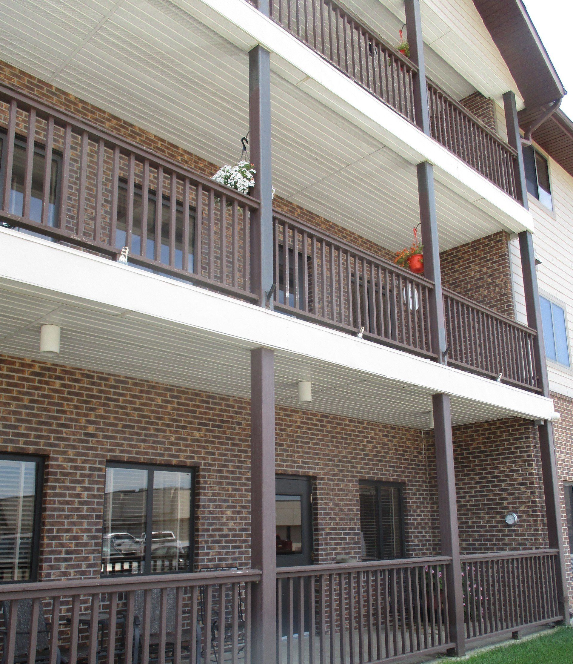 A brick building with a balcony on the second floor