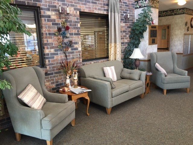 A living room with a couch and two chairs