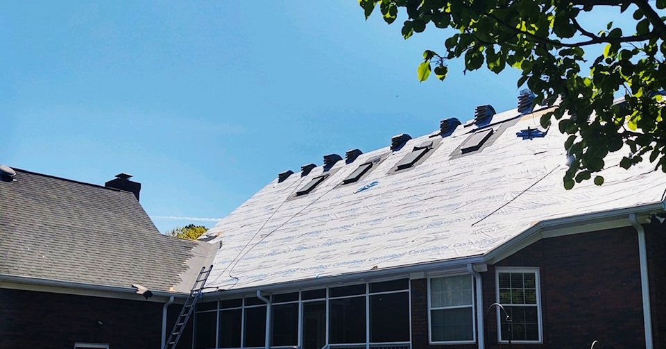 A house with a roof that is being repaired.