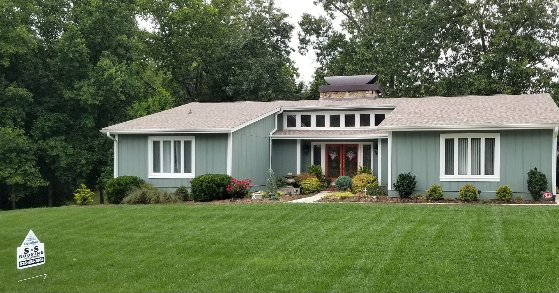 A house with a large lawn in front of it