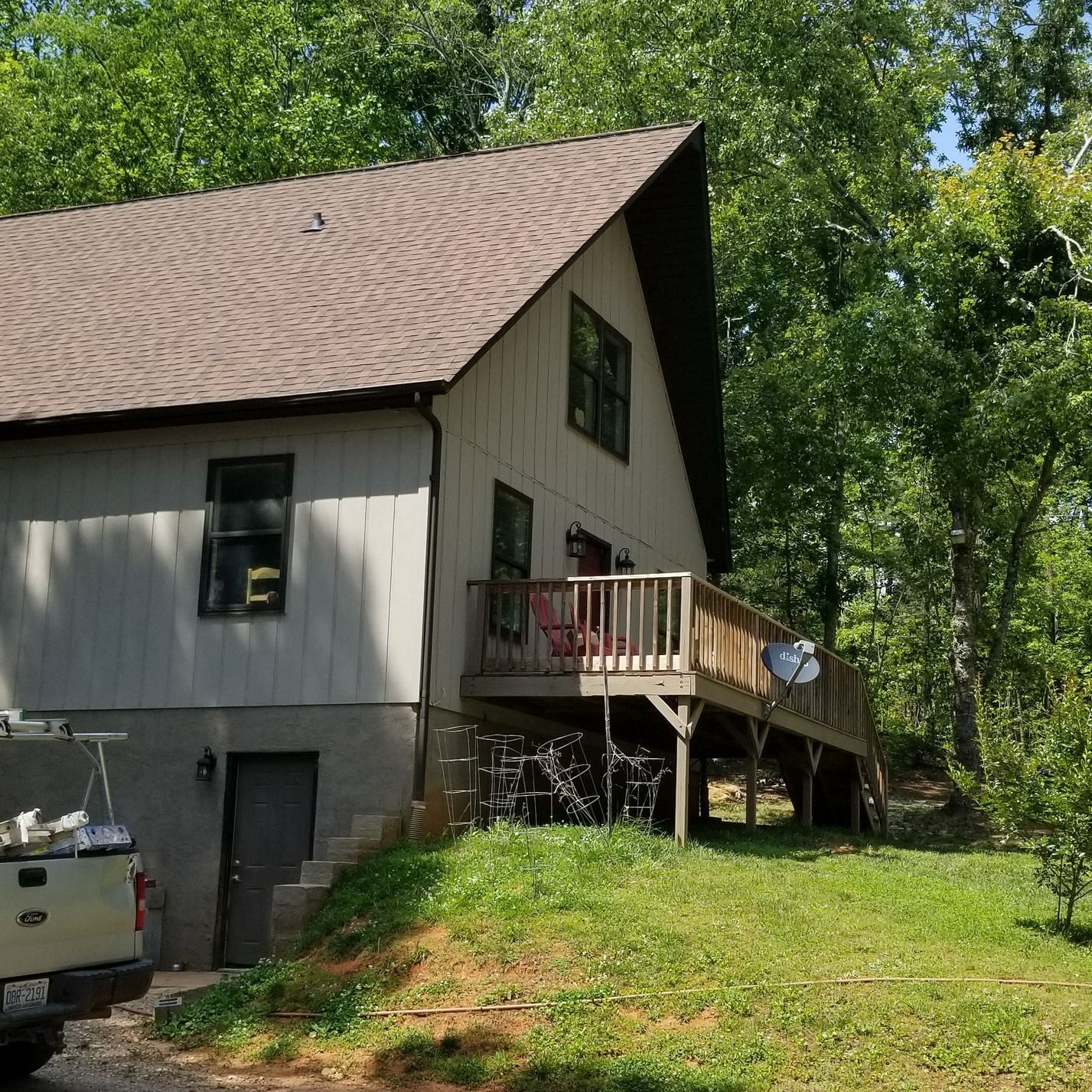 A ford truck is parked in front of a house