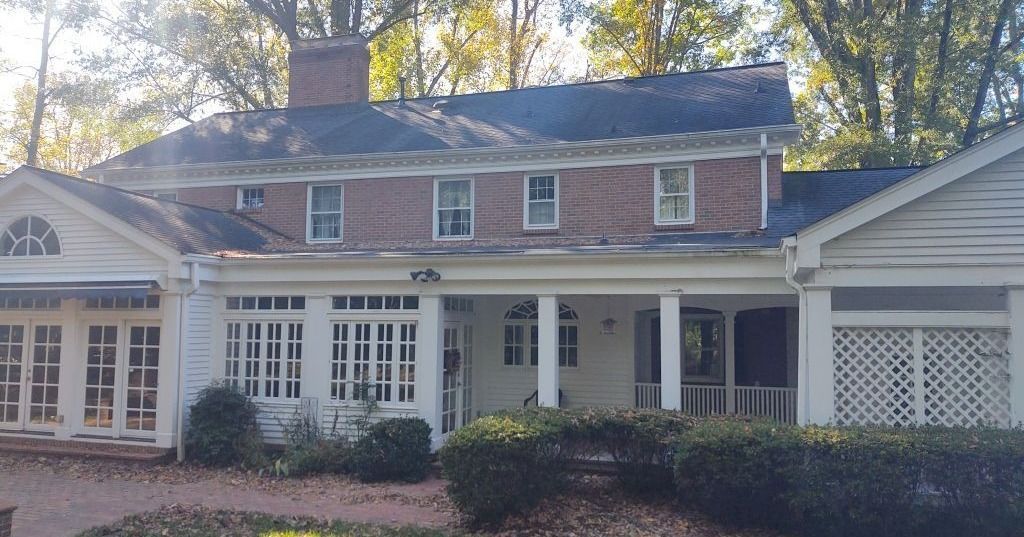 A large brick house with a porch and a garage