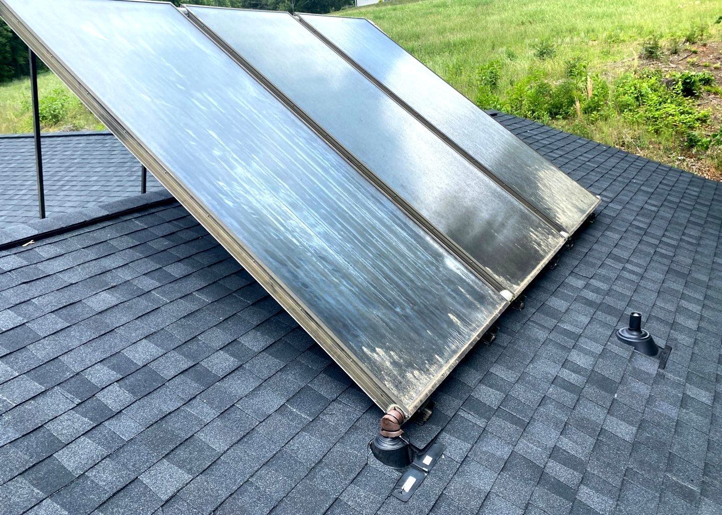 A solar panel is sitting on top of a roof