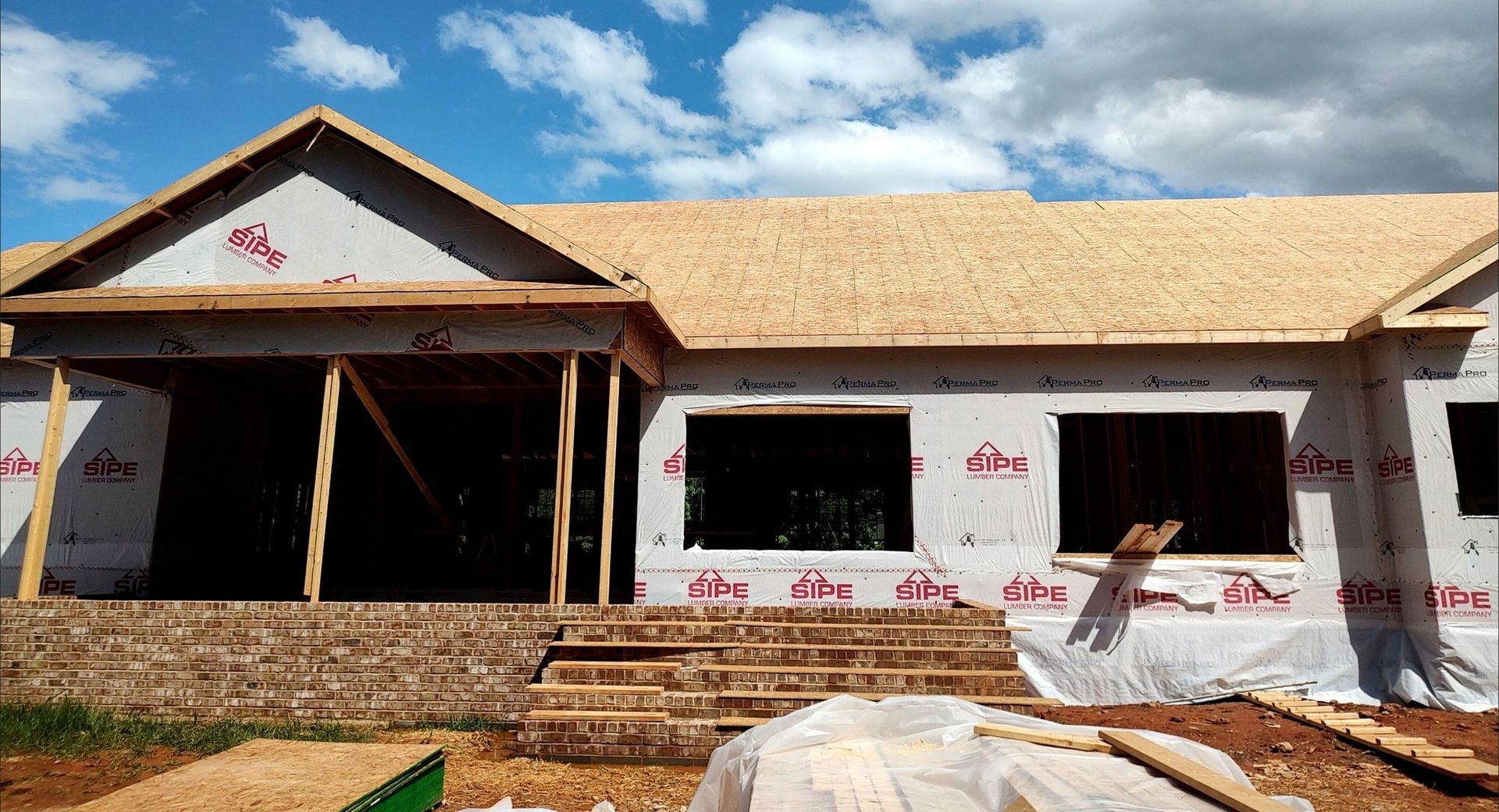 A house is being built with a wooden roof.