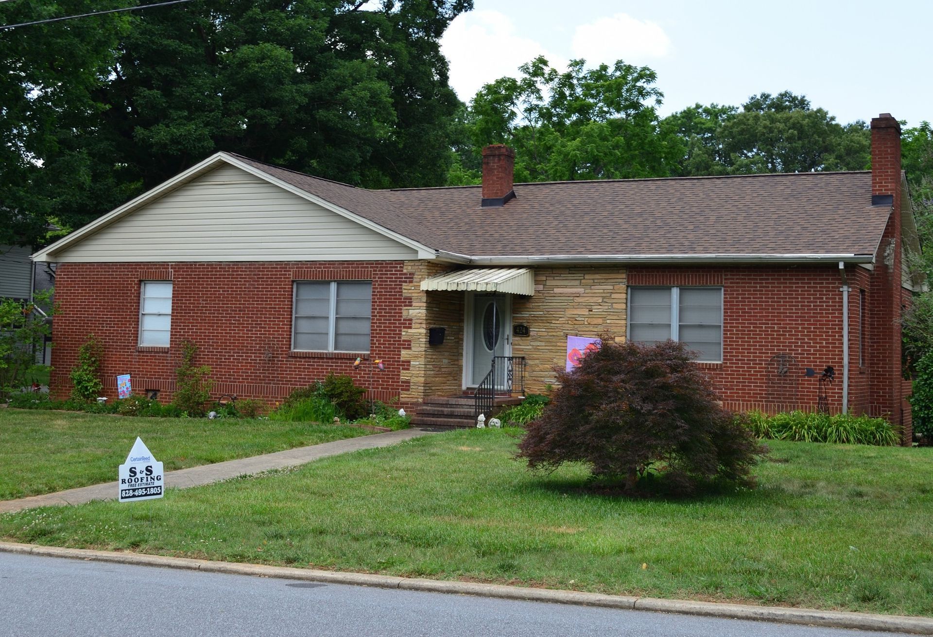 A brick house with a fire hydrant in front of it