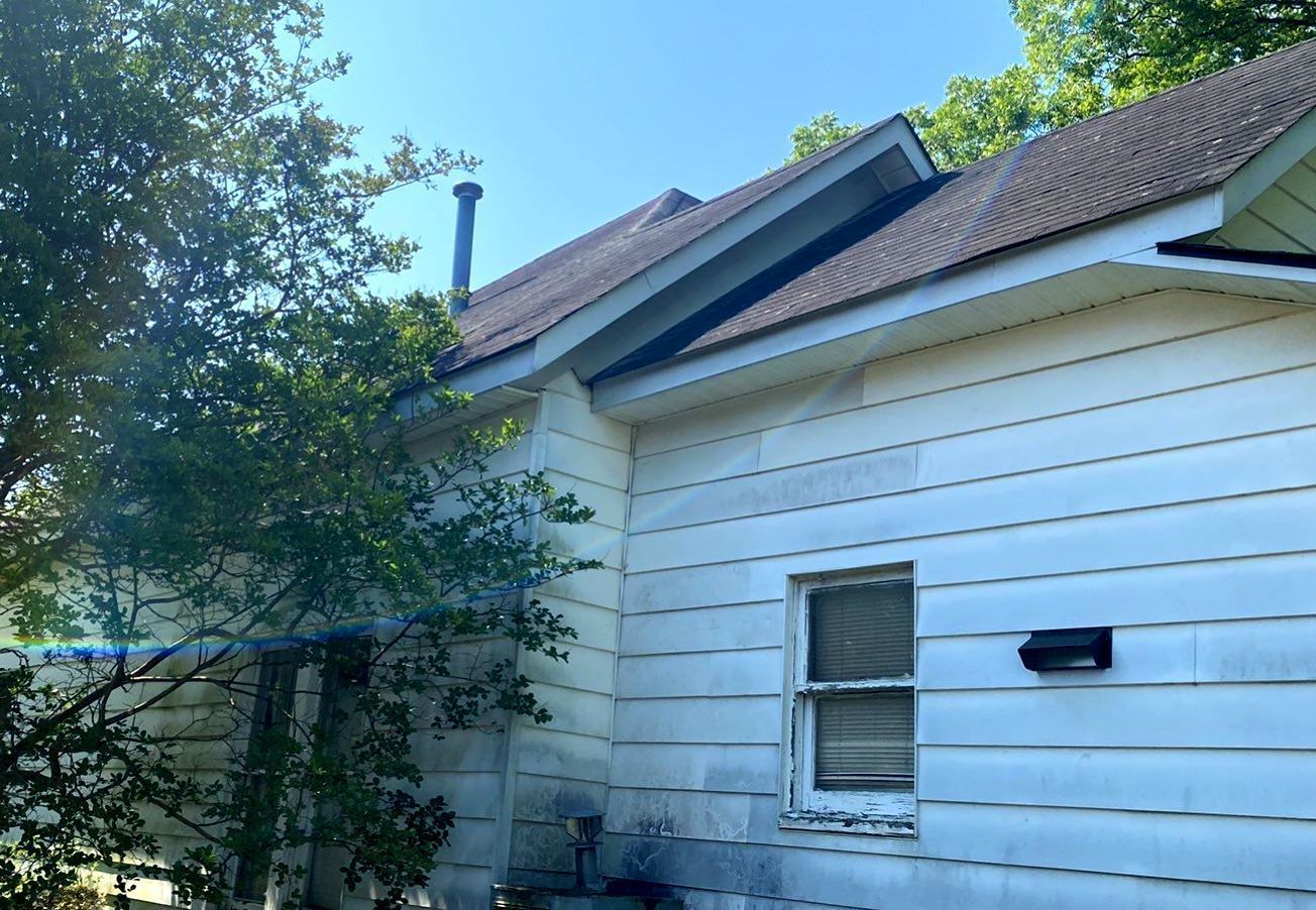 A white house with a red roof and a window