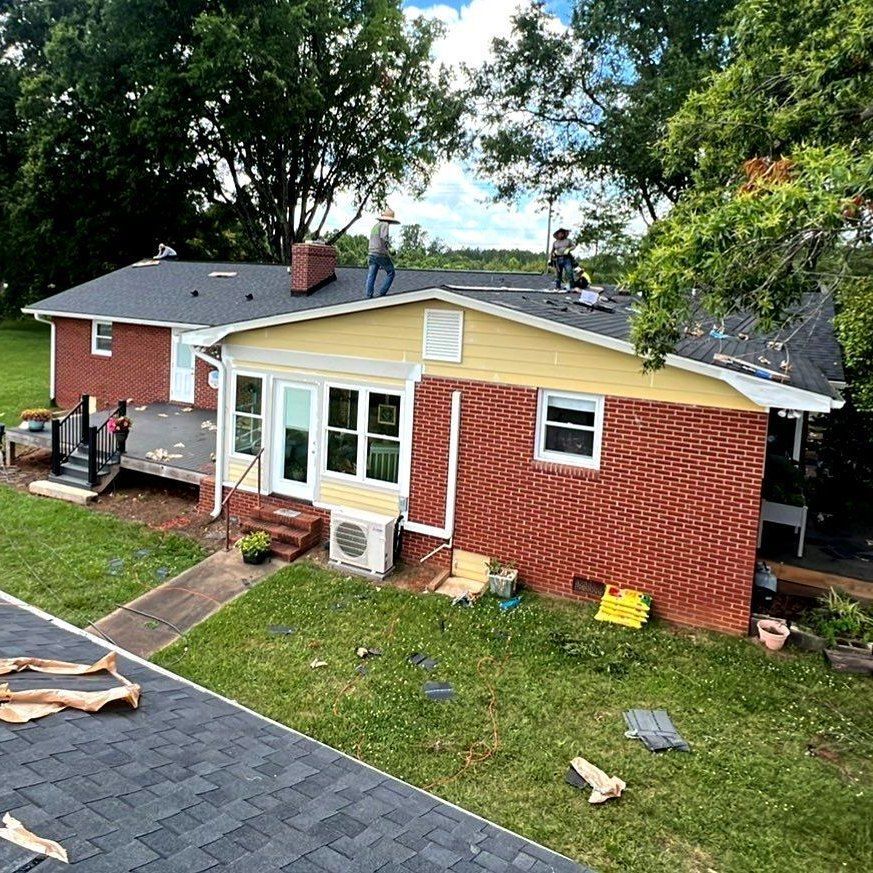 An aerial view of a house being remodeled with a new roof.
