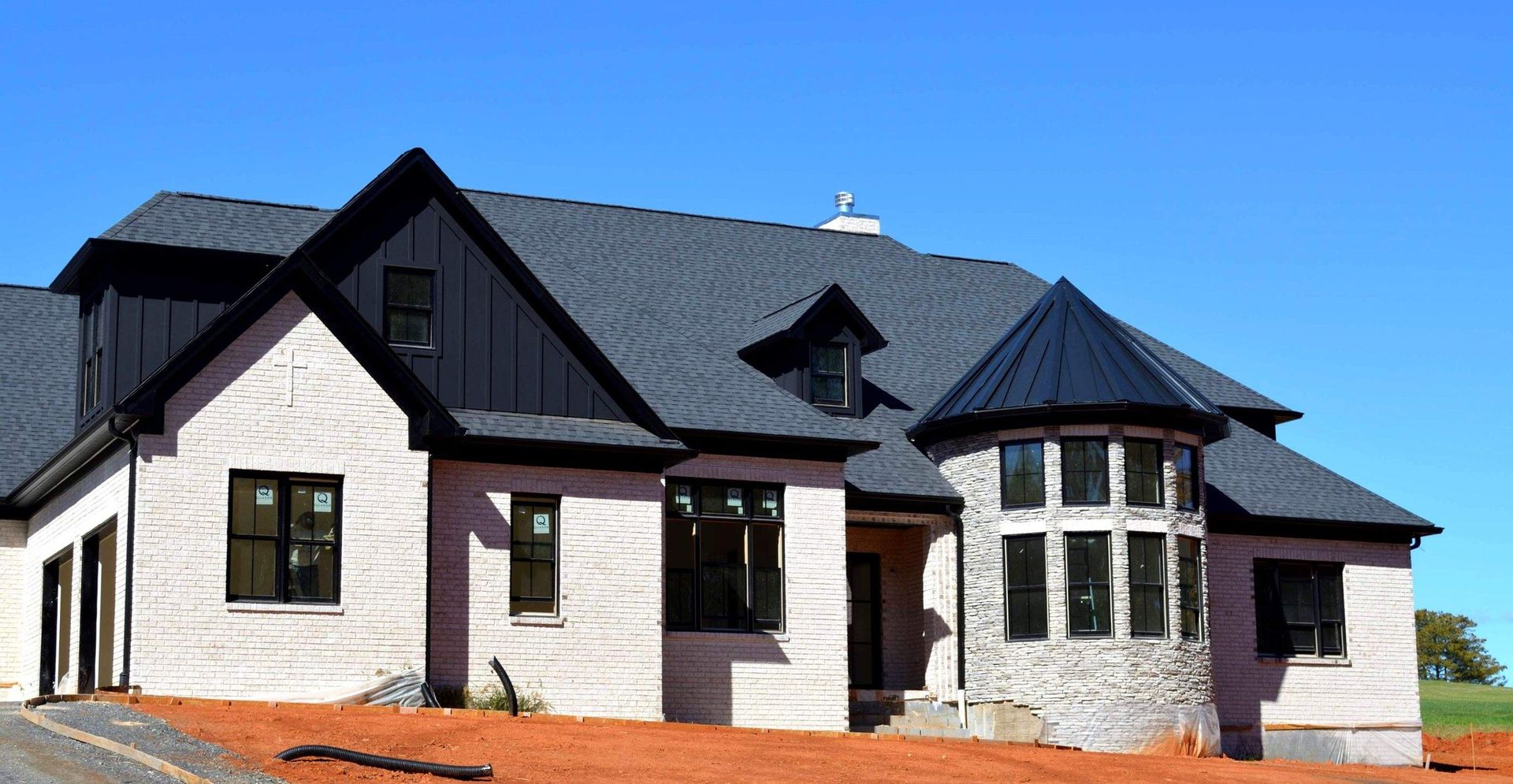 A large white house with a black roof and black windows