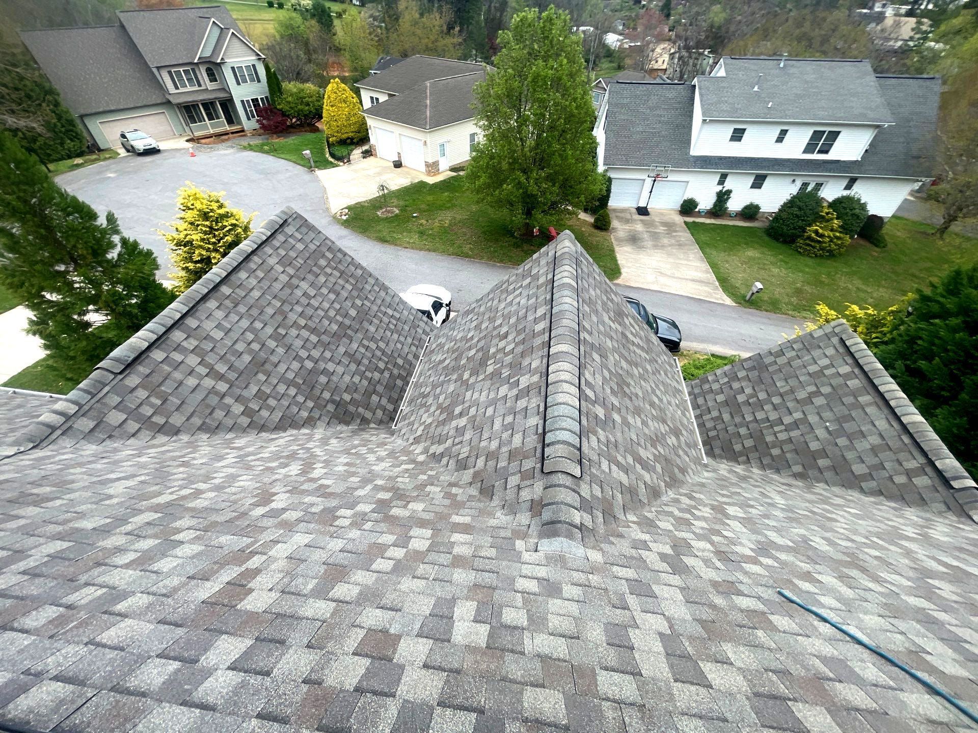 An aerial view of a roof of a house in a residential area.