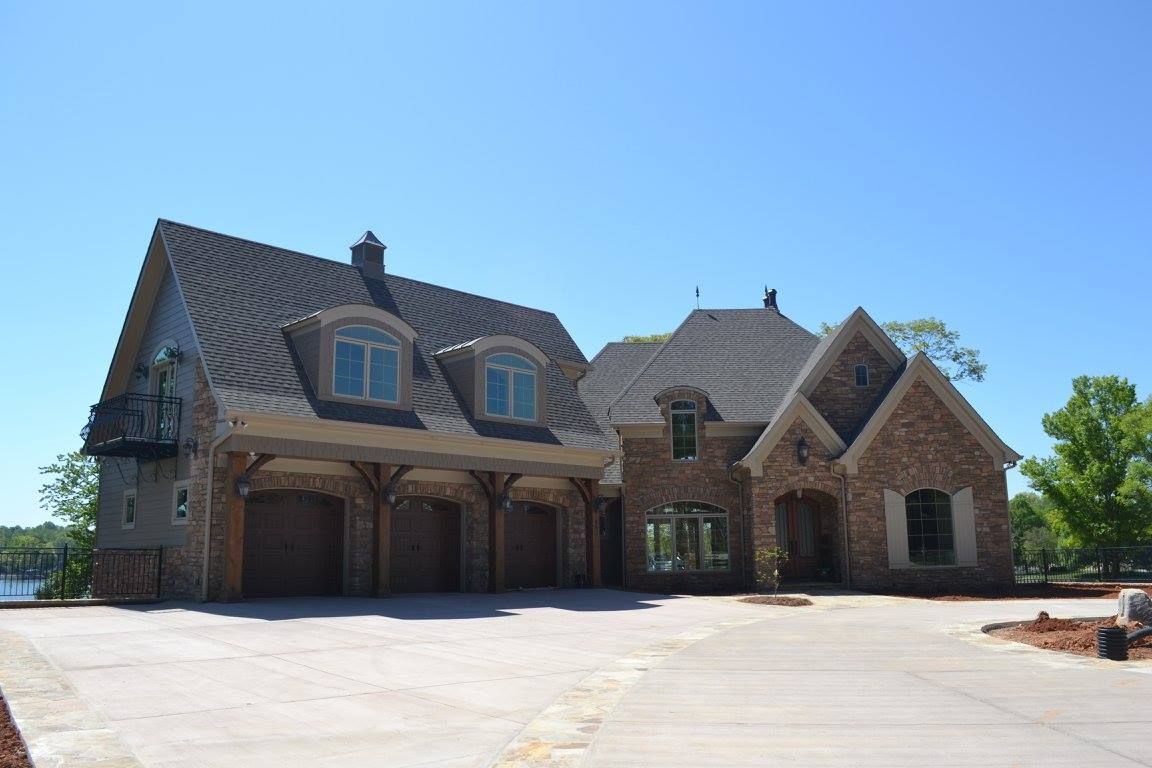 A large brick house with a driveway in front of it