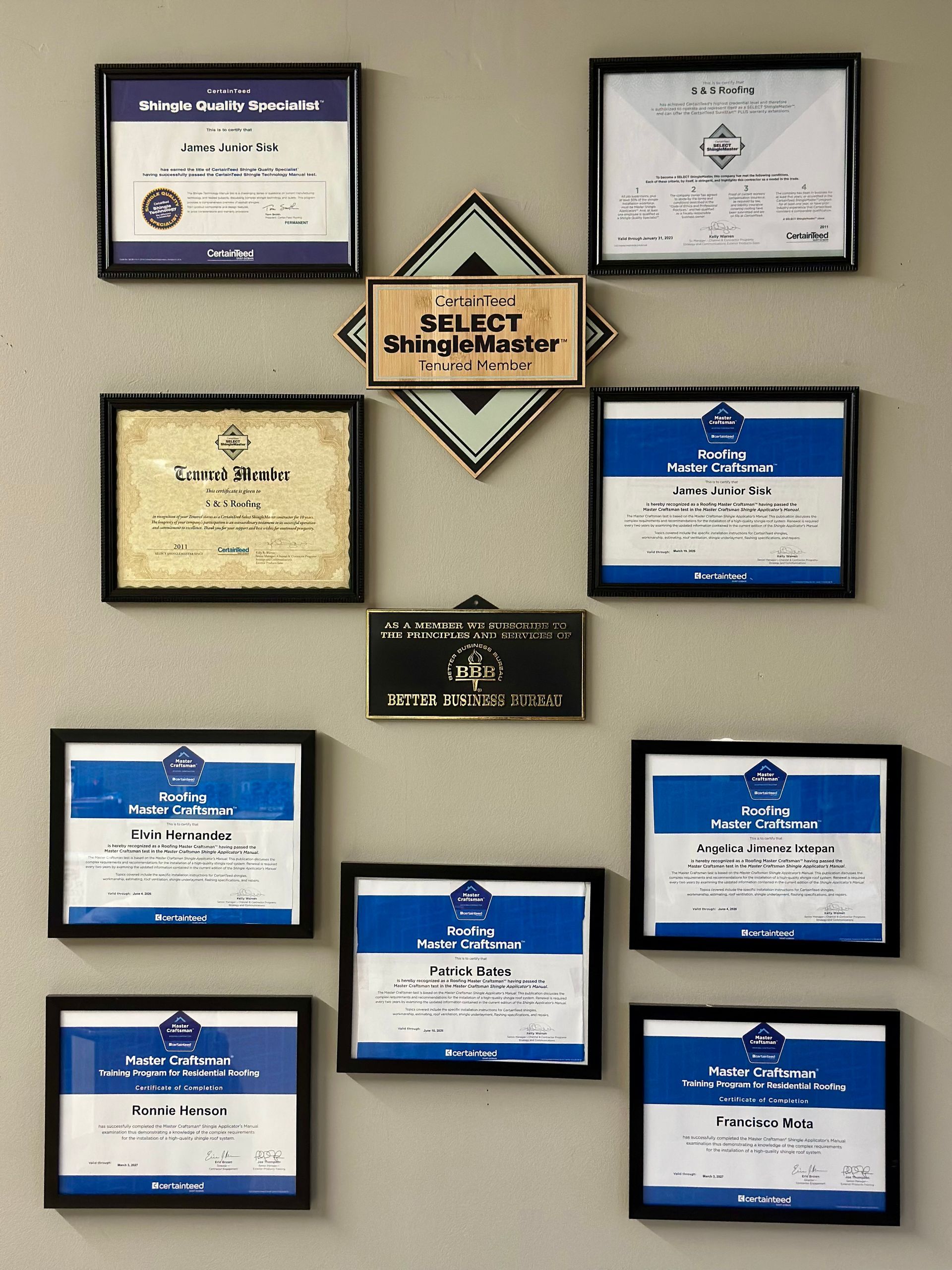 A wall full of plaques including one that says select bright master