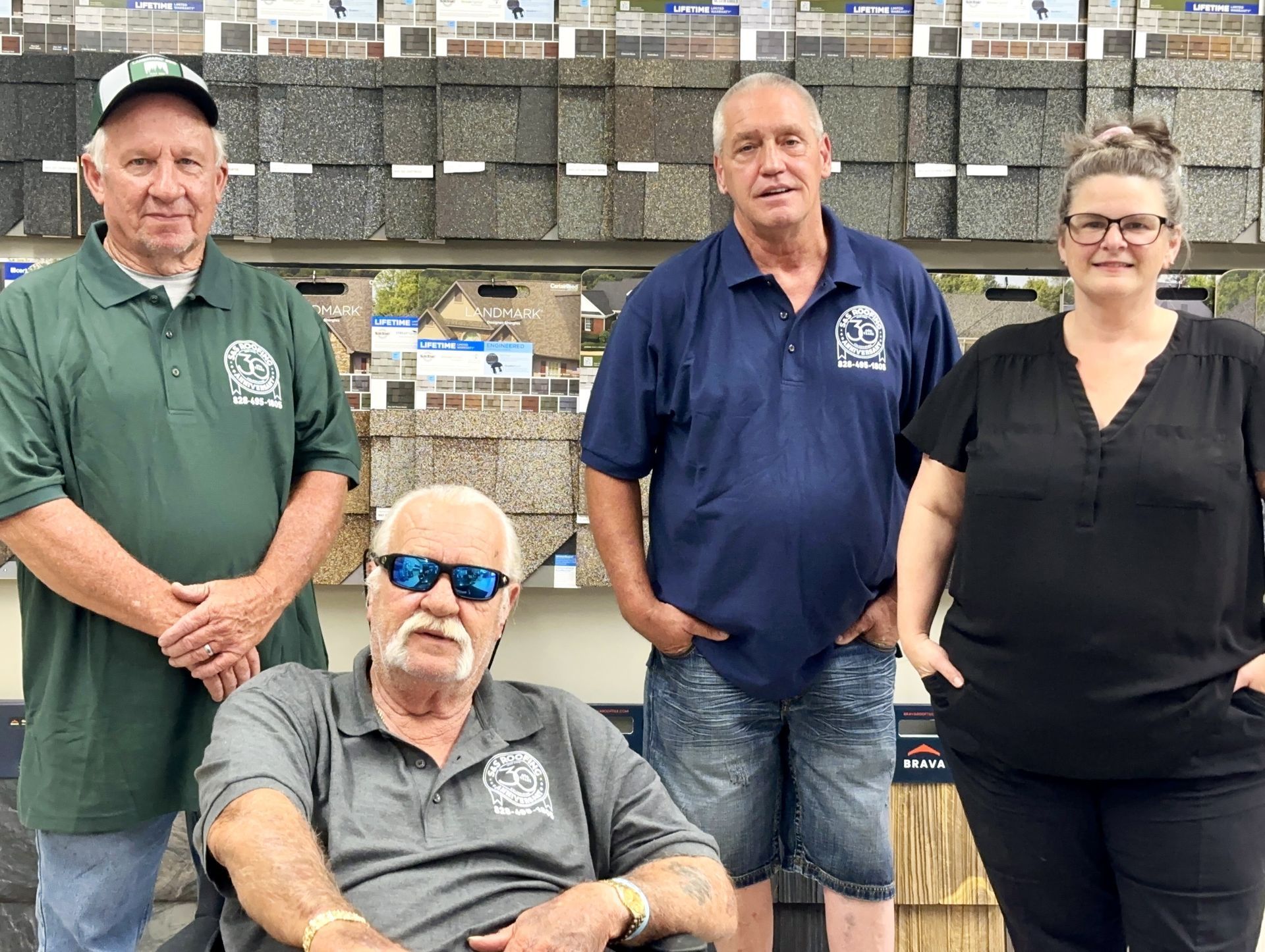 A man wearing a hard hat and goggles is standing in a room.