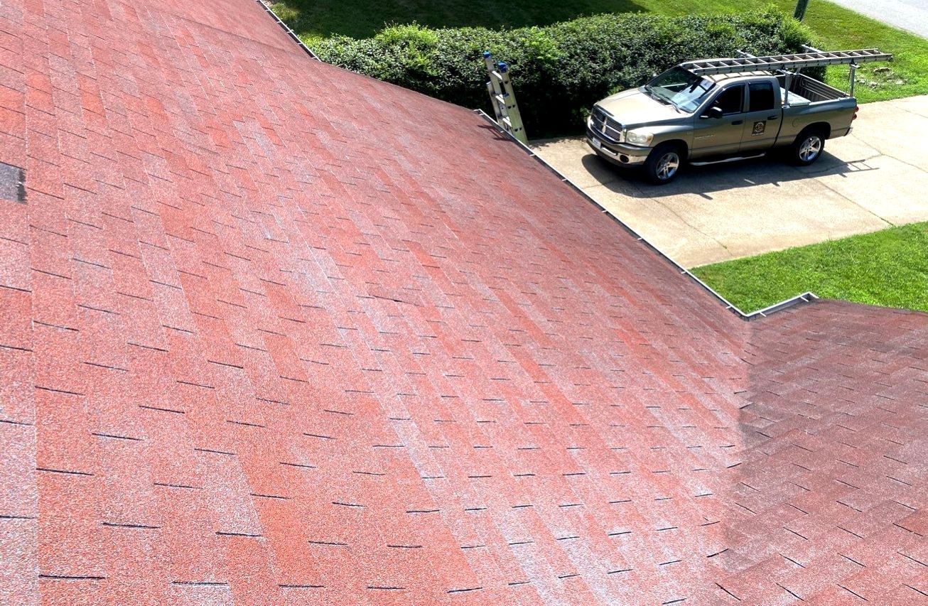 A truck is parked on the roof of a house.