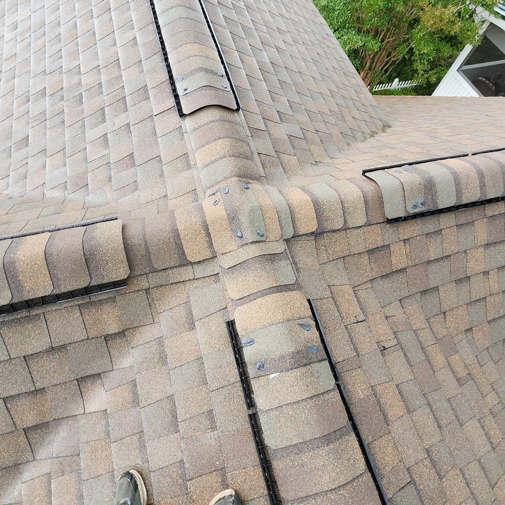 A person is standing on the roof of a house.