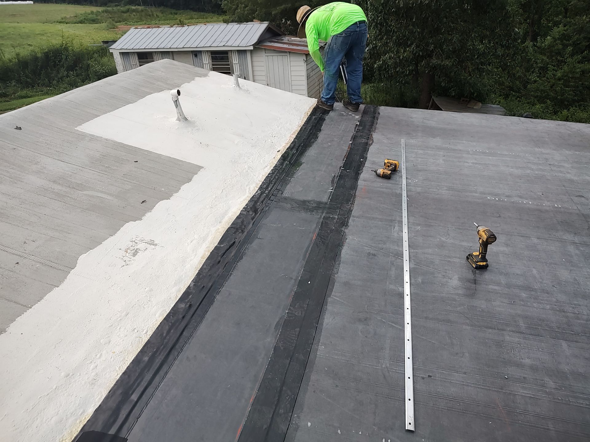 A man is working on the roof of a building.