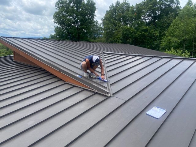 A man is working on a kitchen in a house under construction