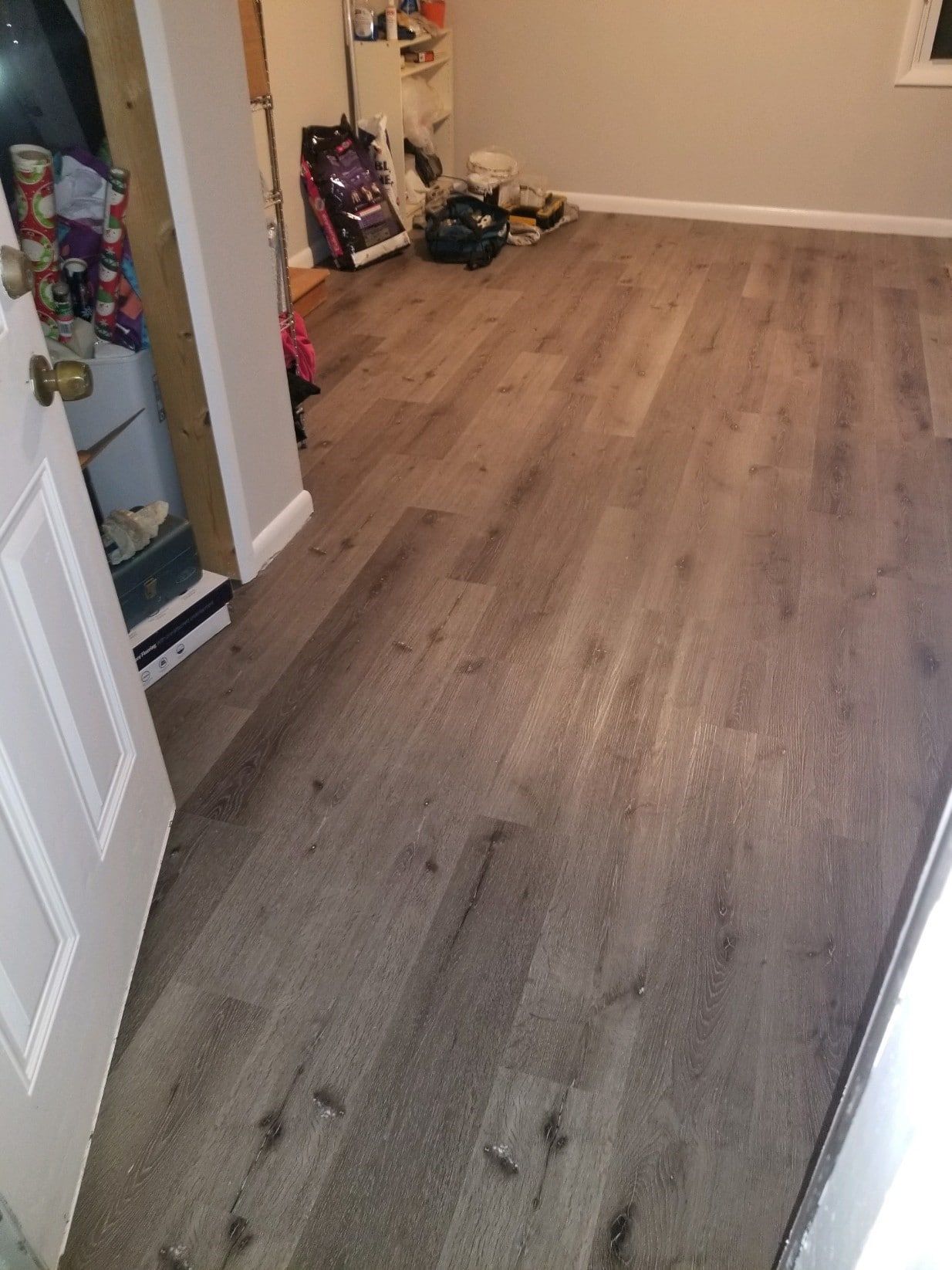 A room with a wooden floor and a door.