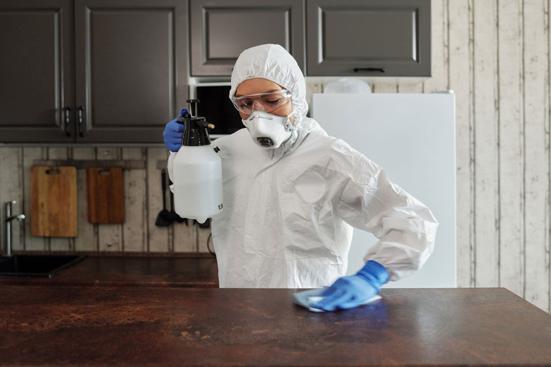 Woman in a suit performing general cleaning and sanitation