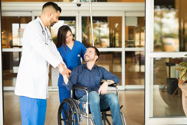 Employment Law Representation — Patient Leaving The Hospital On A Wheelchair in Birmingham, AL