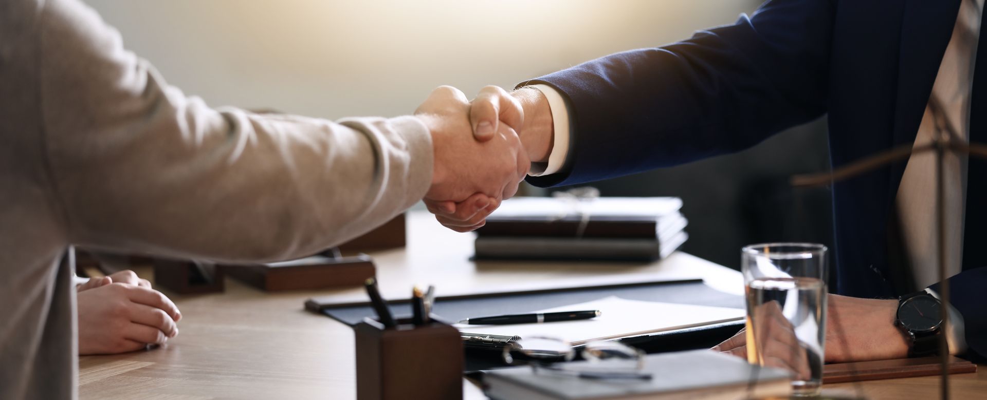 Employment Contract Lawyer reviewing a workplace agreement with a worker. Employment Contract Lawyer reviewing a workplace agreement with a worker.