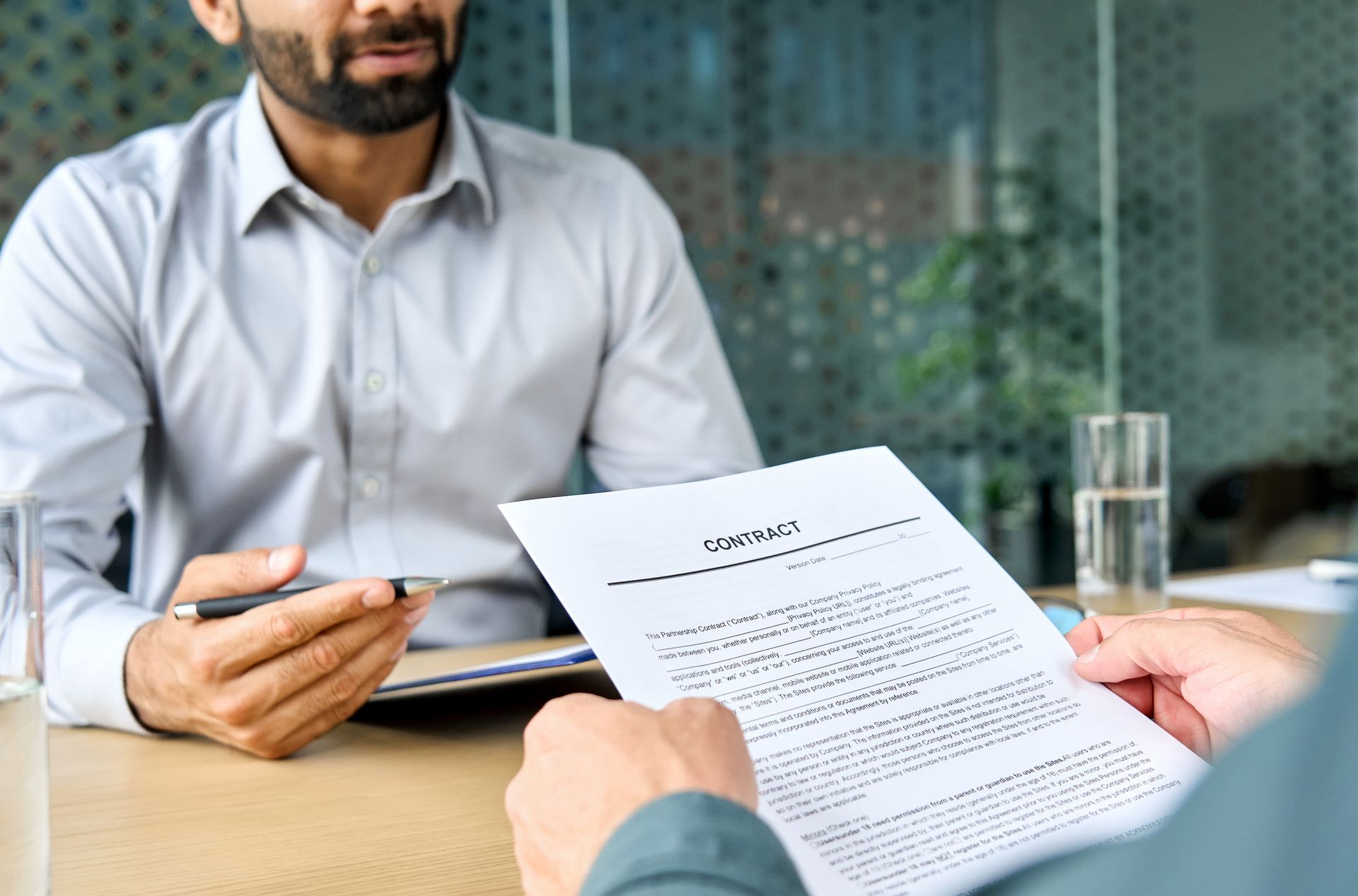 Attorney reviewing employment contract details with a client. Attorney reviewing employment contract details with a client.