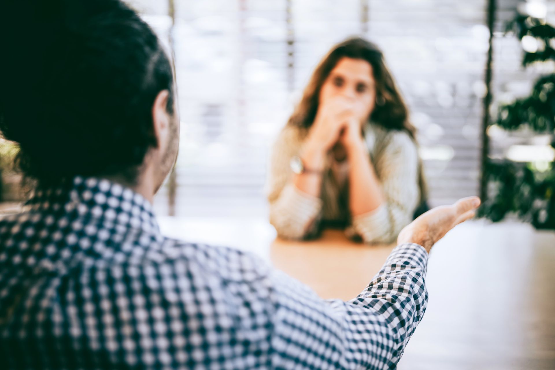A close-up of a woman consulting a discrimination legal attorney about workplace legal concerns.