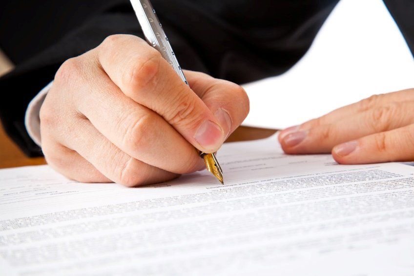 Employment Law — Attorney Writing on A Paper in Birmingham, AL