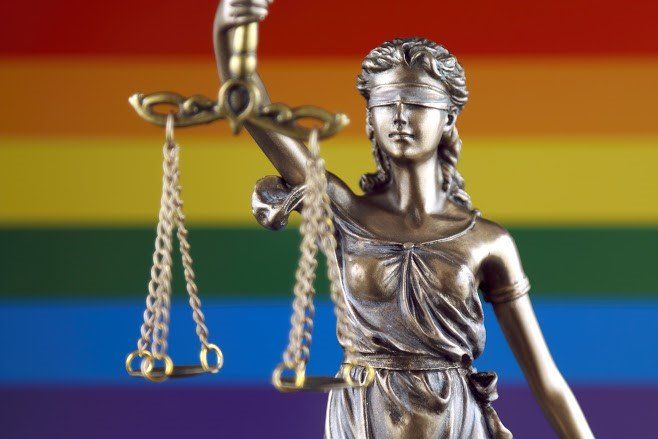 Lady Justice With Rainbow Background — Birmingham, AL — Allen D. Arnold Attorney at Law