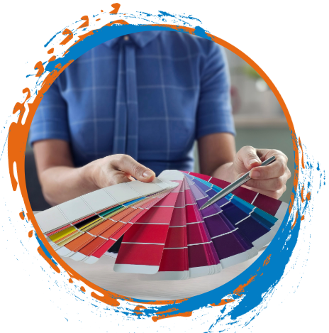 Person holding paint color swatches, selecting colors with a pen.