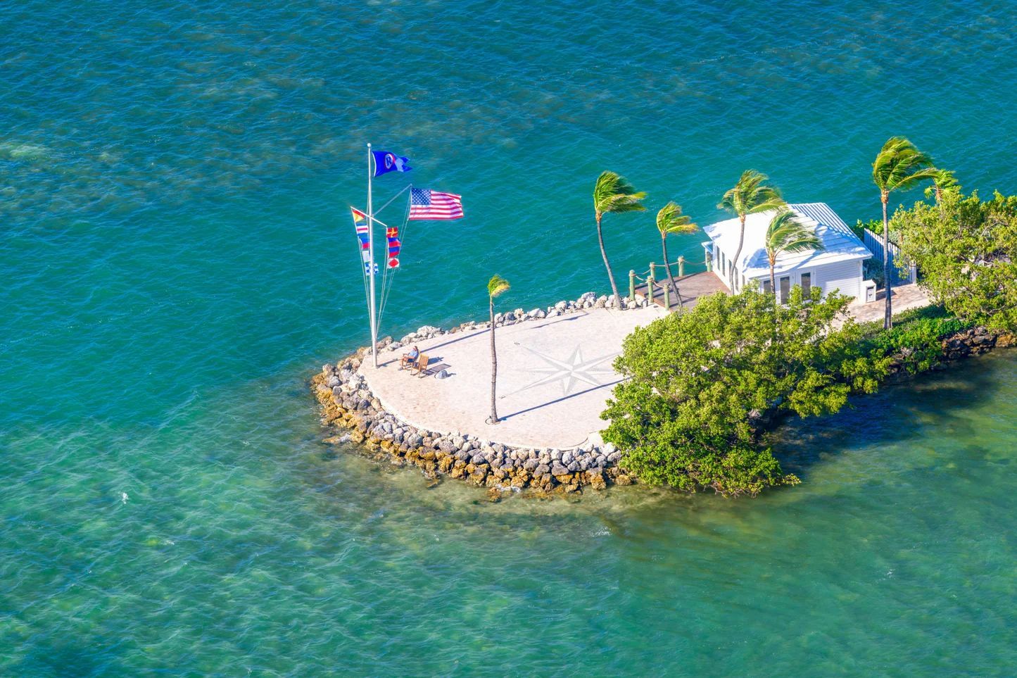 An aerial view of a small island in the middle of the ocean.