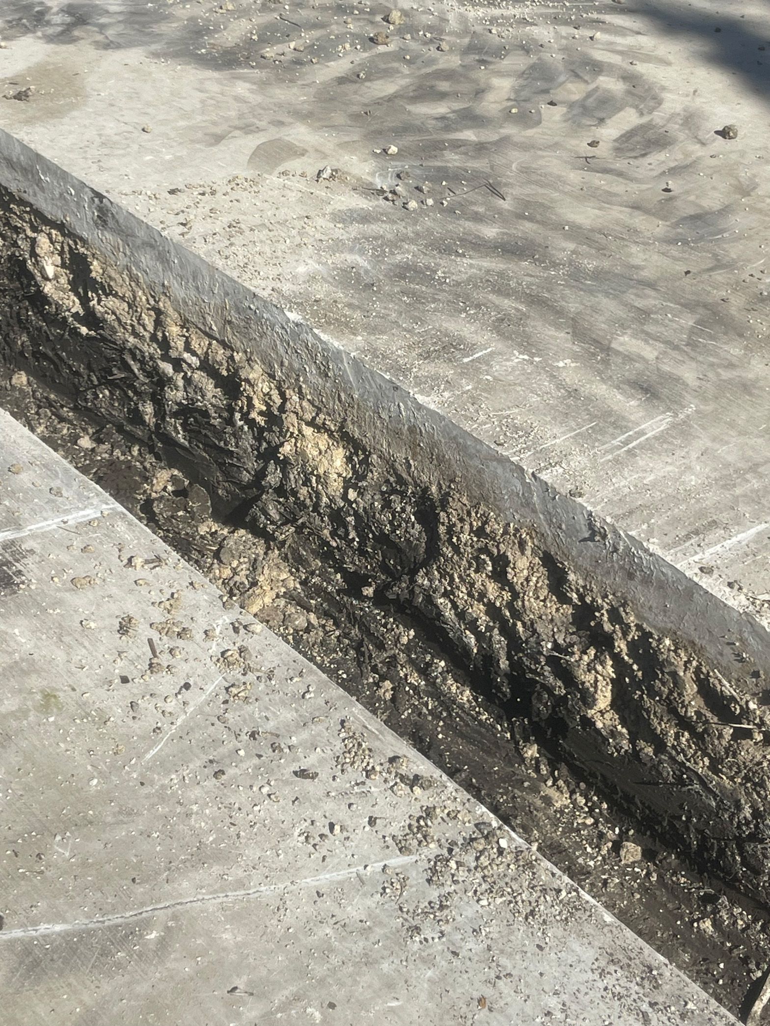 A close up of a concrete surface with a lot of dirt on it.