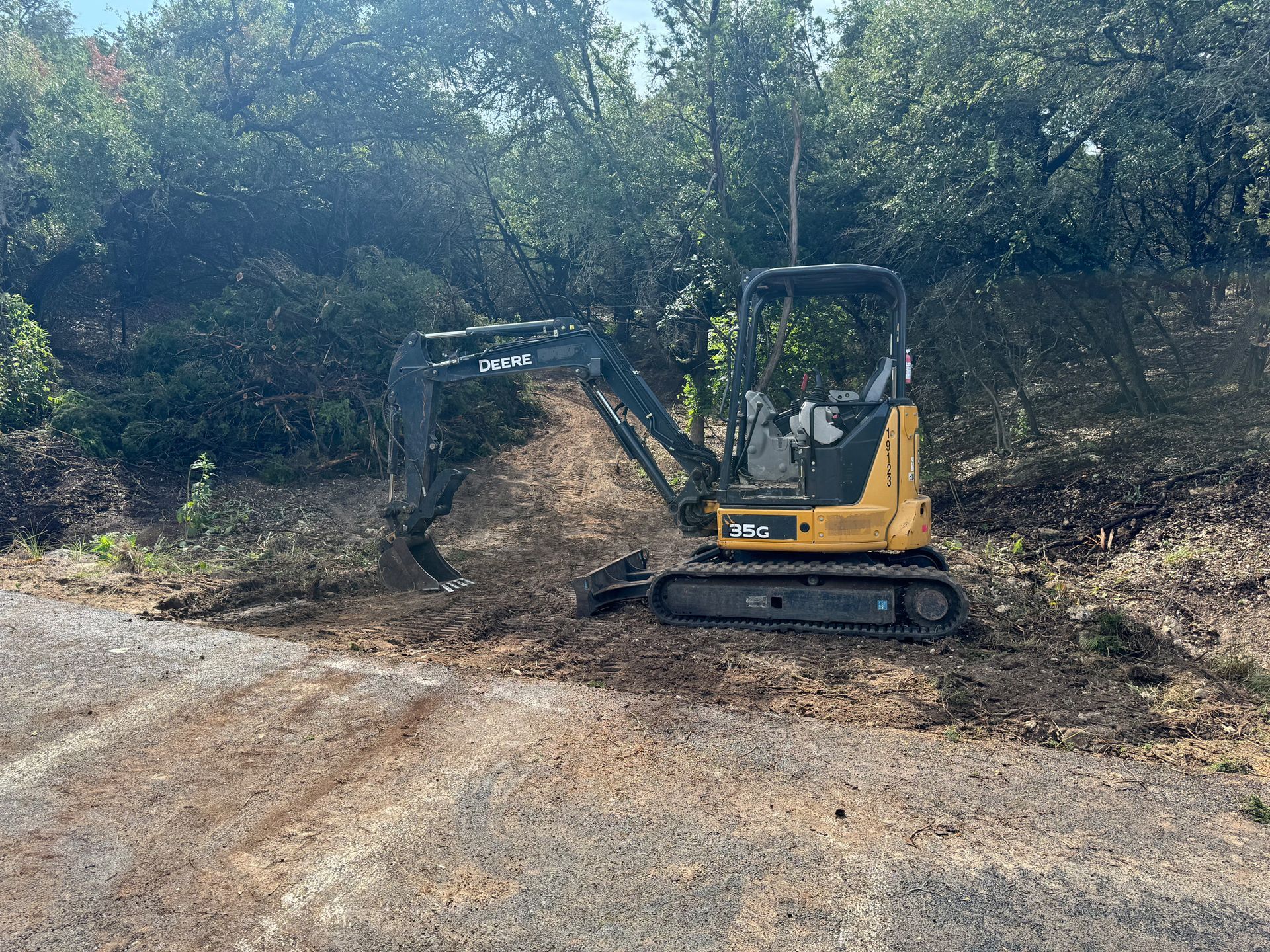 A small excavator is digging a hole in the dirt.