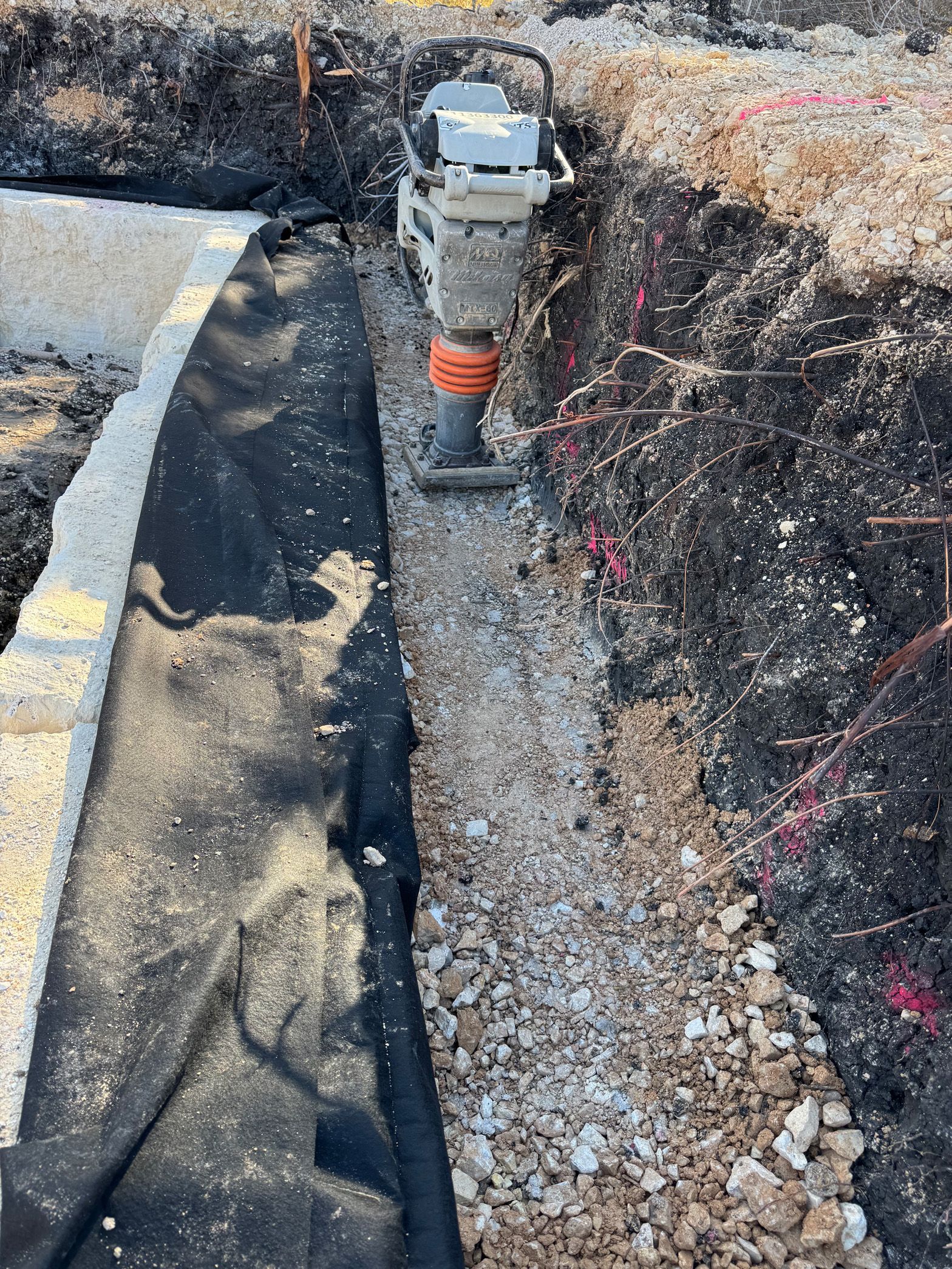 A machine is sitting in a hole in the ground.