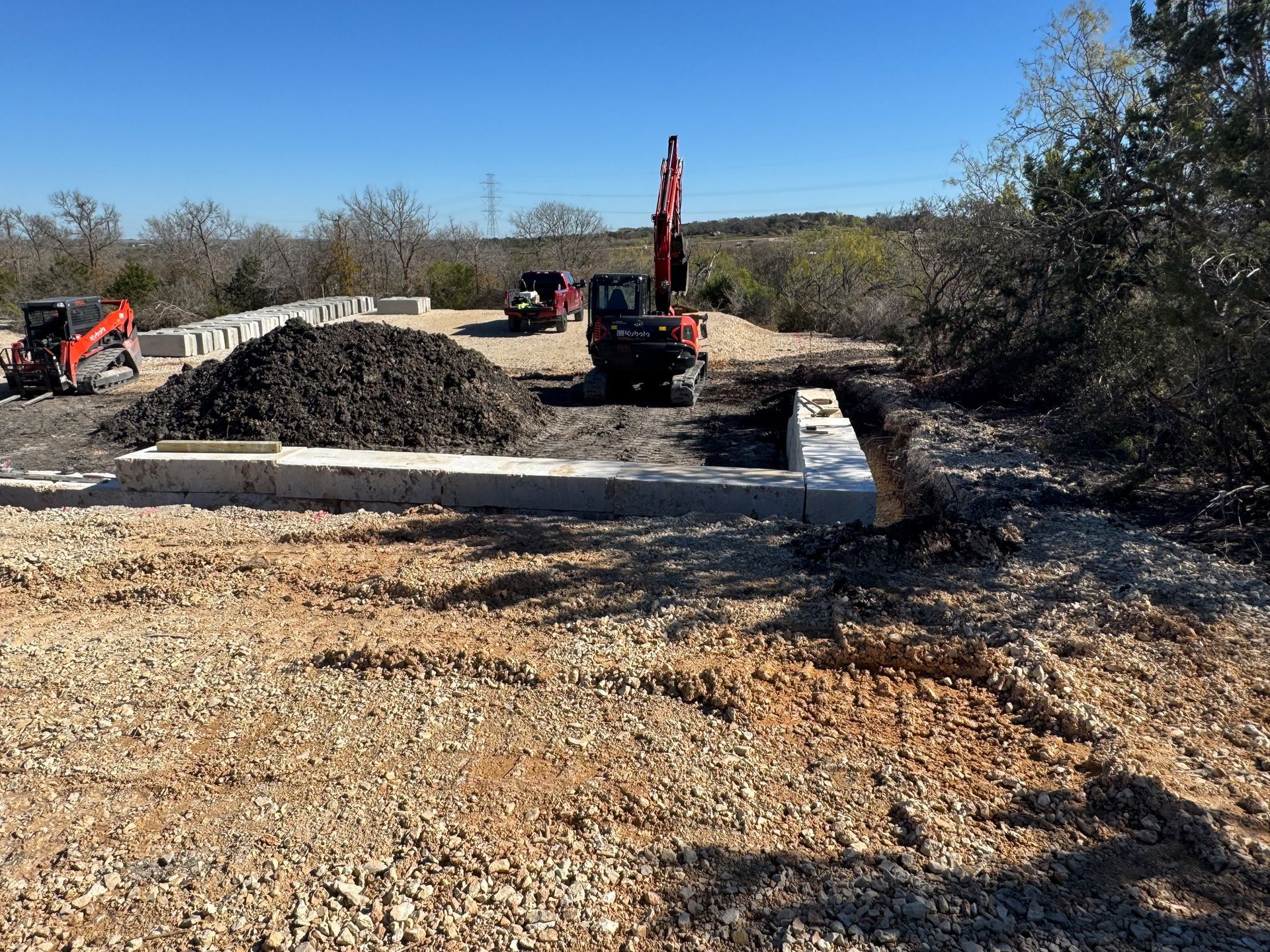 A large pile of dirt is sitting in the middle of a dirt field.