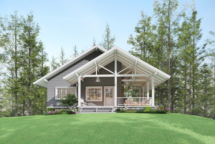 A small house with a porch in the middle of a forest.