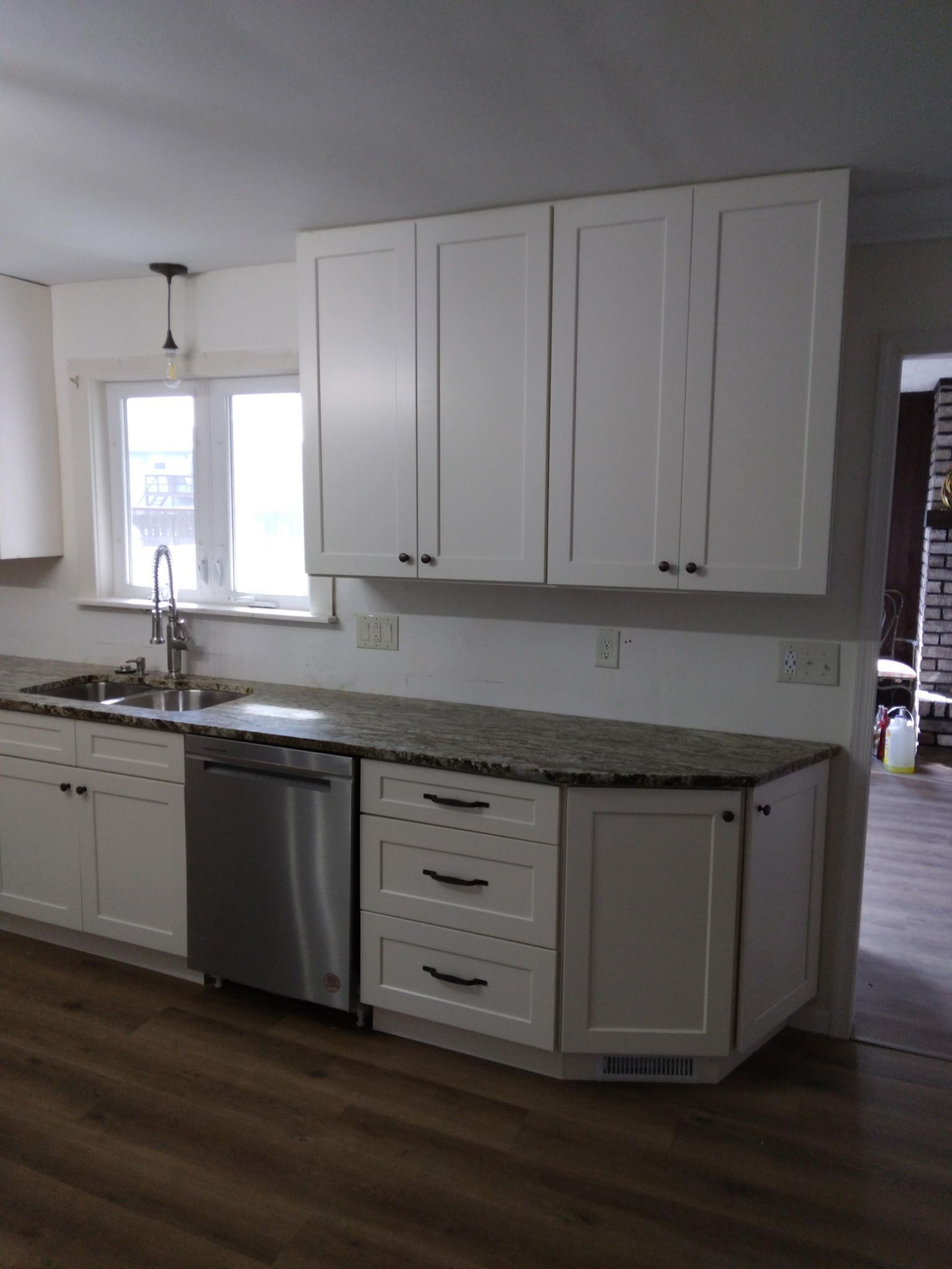 White kitchen cabinets, stainless steel appliances, granite countertops.