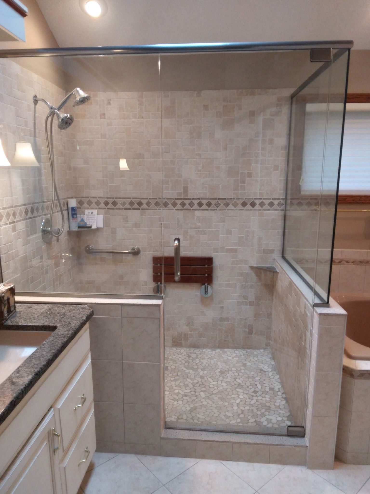 Bright kitchen with white cabinets, wood island, stainless steel appliances, and wooden floors.