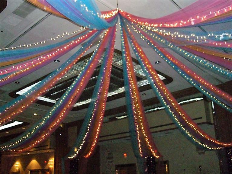 A ceiling decorated with colorful ribbons and lights