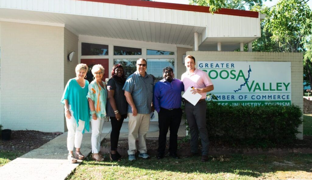 Group of people in front of a building with a sign that reads 