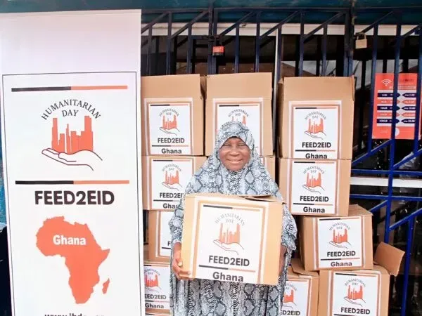 Woman holds a box of food for 