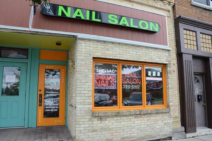 A nail salon is located in a brick building