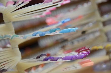 A close up of a display of nail polish in a store.