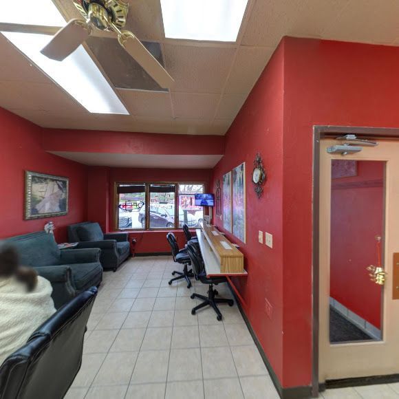 A room with red walls and a ceiling fan