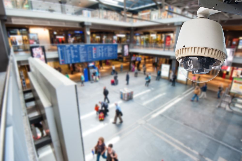 A Security Camera is Hanging From the Ceiling of a Shopping Mall — Cambush Security Solutions NT in Palmerston, NT