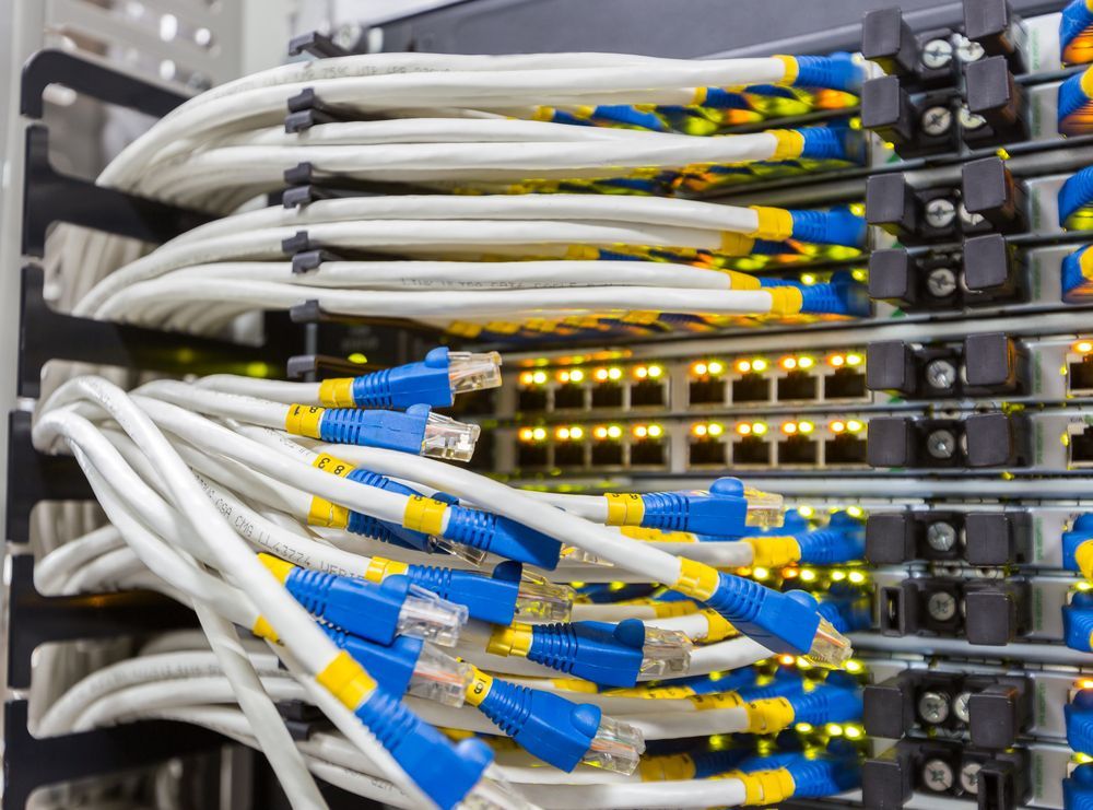 A Bunch of Wires Are Connected to a Server in a Data Center — Cambush Security Solutions NT in Palmerston, NT