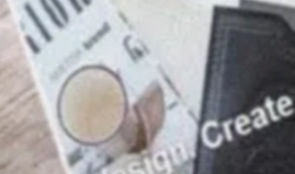 Magazine with a circle design, and a black booklet with the word 