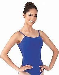 Woman in a blue leotard and a ballet bun, smiling with hands on hips.
