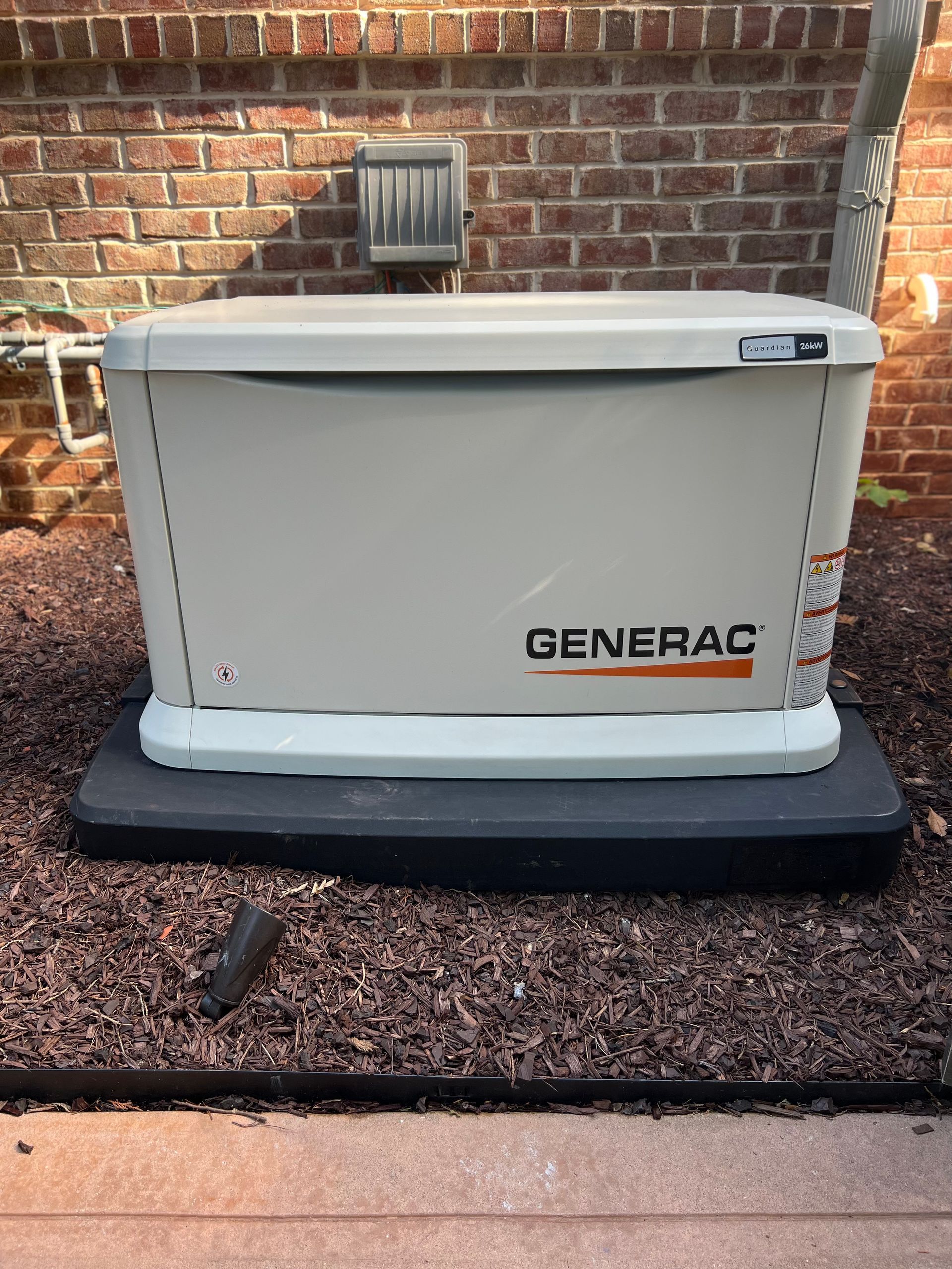 Person using a screwdriver to install an electrical outlet on a wall.